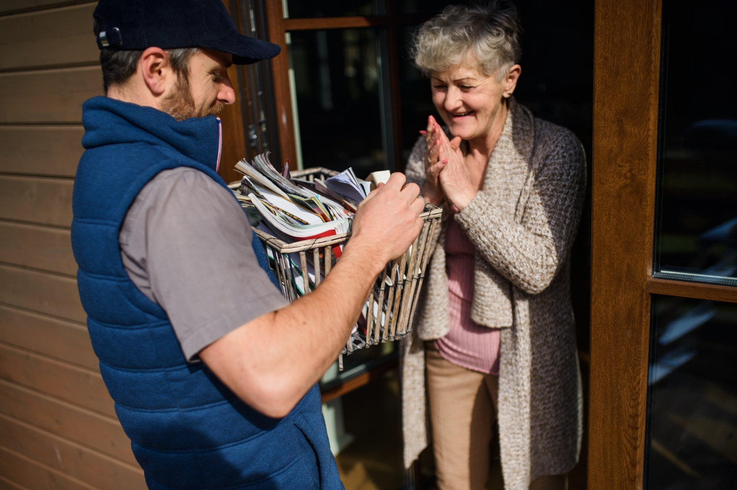 Person delivering books to person at home