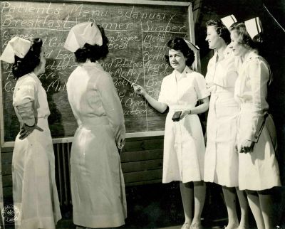 Nurses around a chalkboard